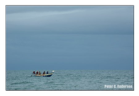 Fisherman lay down their nets as a storm approaches.