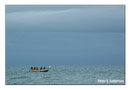 Fisherman lay down their nets as a storm approaches.